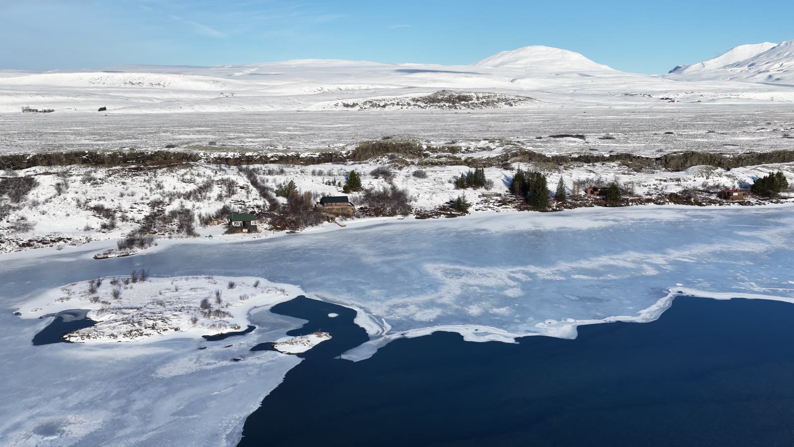 Aerial view of a frozen lake and snowy plains at Þingvellir National Park in winter