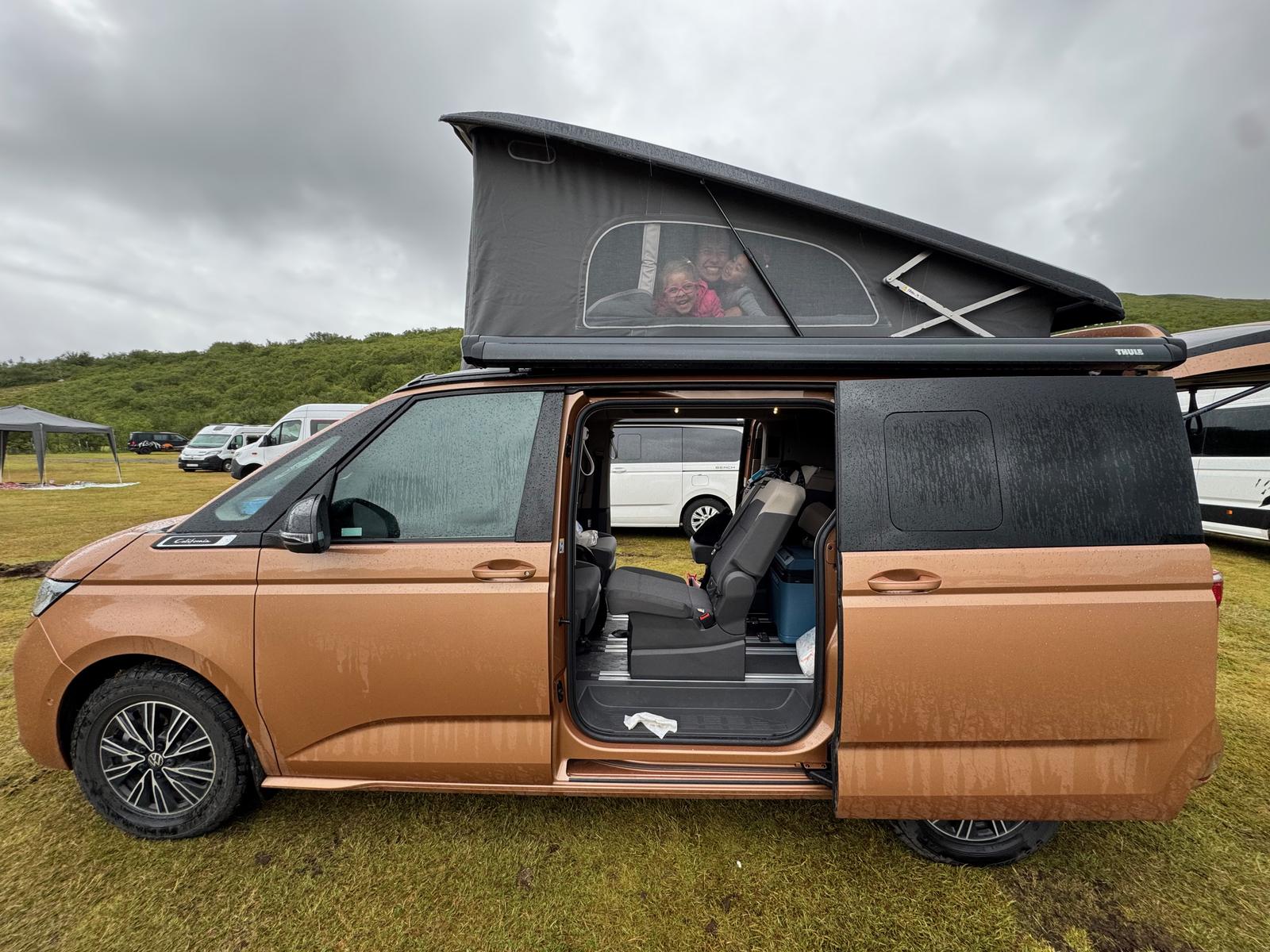 Copper VW California Beach camper van with its pop-top roof raised at Skaftafell campsite