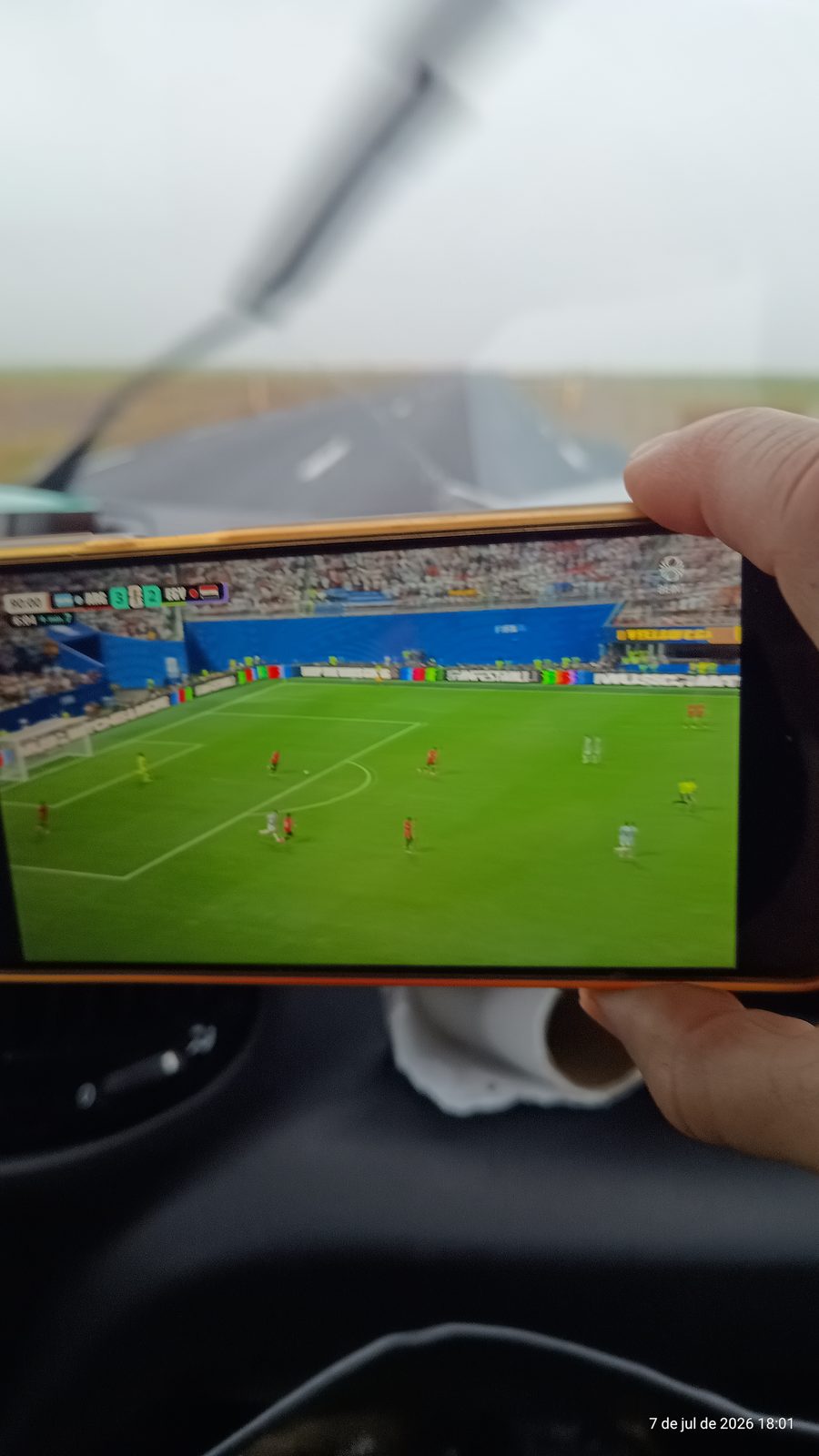 Watching the Argentina versus Egypt World Cup match on a phone inside the camper on a rainy day